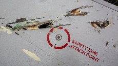 Повреждения на крыле потерпевшего крушение лайнера Boeing 777 Малайзийских авиалиний в районе села Рассыпное Донецкой области. Архивное фото Повреждения на крыле потерпевшего крушение лайнера Boeing 777 Малайзийских авиалиний в районе села Рассыпное Донецкой области. Архивное фото
