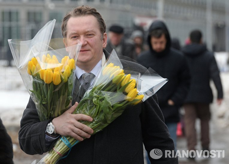 Мужчина с букетами цветов в преддверии праздника 8 марта в Москве Мужчина с букетами цветов в преддверии праздника 8 марта в Москве