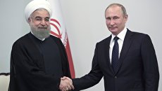 Президент России Владимир Путин и президент Исламской Республики Иран Хасан Рухани во время встречи в Центре Гейдара Алиева в Баку. 8 августа 2016 Президент России Владимир Путин и президент Исламской Республики Иран Хасан Рухани во время встречи в Центре Гейдара Алиева в Баку. 8 августа 2016