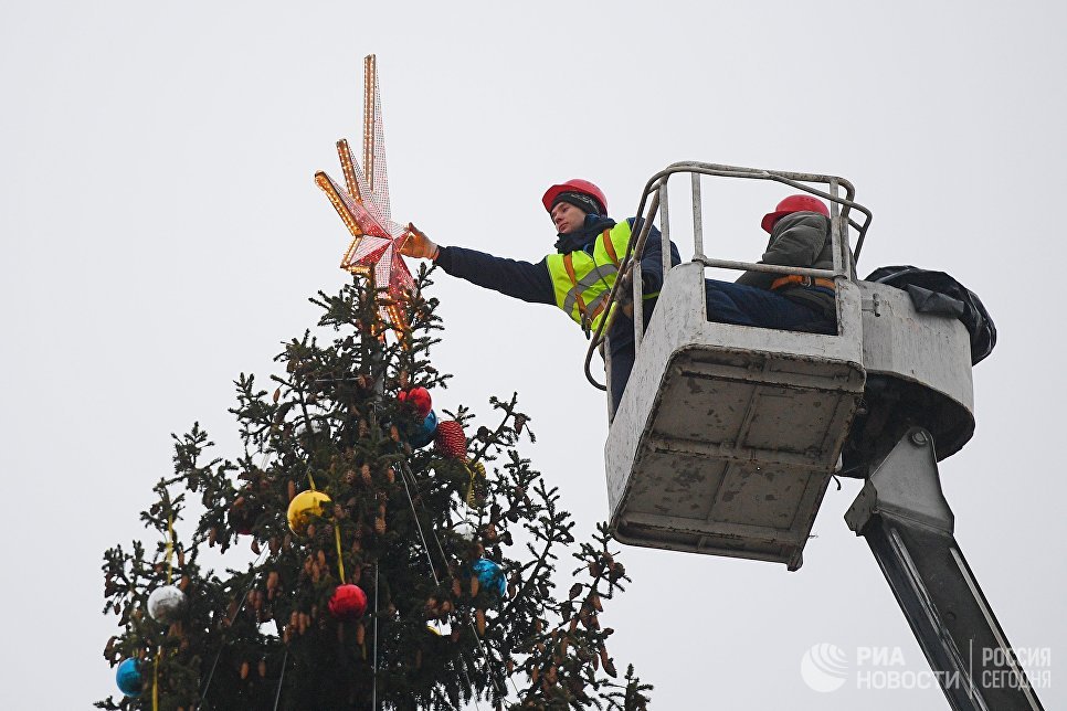 Рабочие украшают Новогоднюю ёлку на Соборной площади Кремля в Москве Рабочие украшают Новогоднюю ёлку на Соборной площади Кремля в Москве