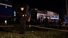 Сотрудники правоохранительных органов стоят в оцеплении на месте столкновения пассажирского поезда и электрички в районе улицы Герасима Курина в Москве Сотрудники правоохранительных органов стоят в оцеплении на месте столкновения пассажирского поезда и электрички в районе улицы Герасима Курина в Москве