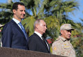 Владимир Путин, президент Сирийской Арабской Республики Башар Асад и министр обороны России Сергей Шойгу во время посещения авиабазы Хмеймим в Сирии. 11 декабря 2017 Владимир Путин, президент Сирийской Арабской Республики Башар Асад и министр обороны России Сергей Шойгу во время посещения авиабазы Хмеймим в Сирии. 11 декабря 2017