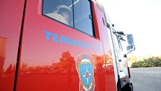 Пожарный специализированной пожарно-спасательной части. Архивное фото Пожарный специализированной пожарно-спасательной части. Архивное фото
