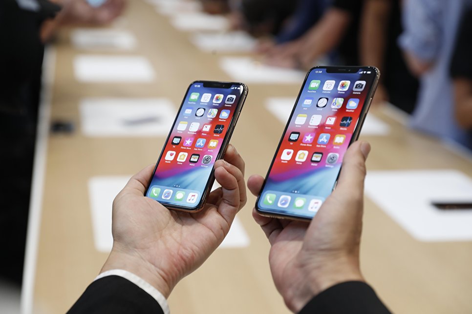 Человек держит новый Apple iPhone XS и XS Max. 12 сентября 2018 года Человек держит новый Apple iPhone XS и XS Max. 12 сентября 2018 года