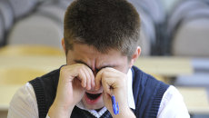 A man yawns.  Archival photo